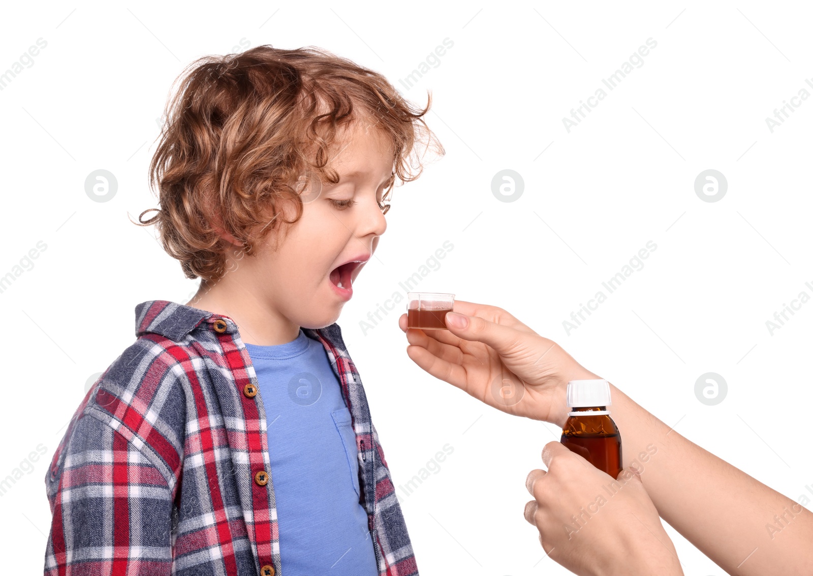 Photo of Mother giving cough syrup to her son against white background, closeup