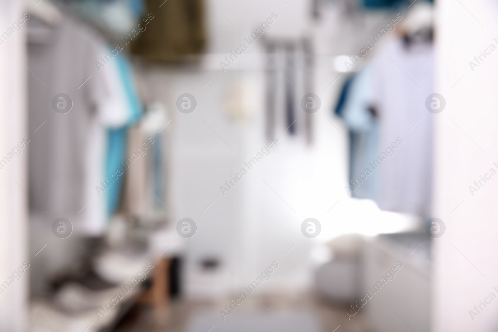 Photo of Blurred view of modern dressing room with stylish clothes