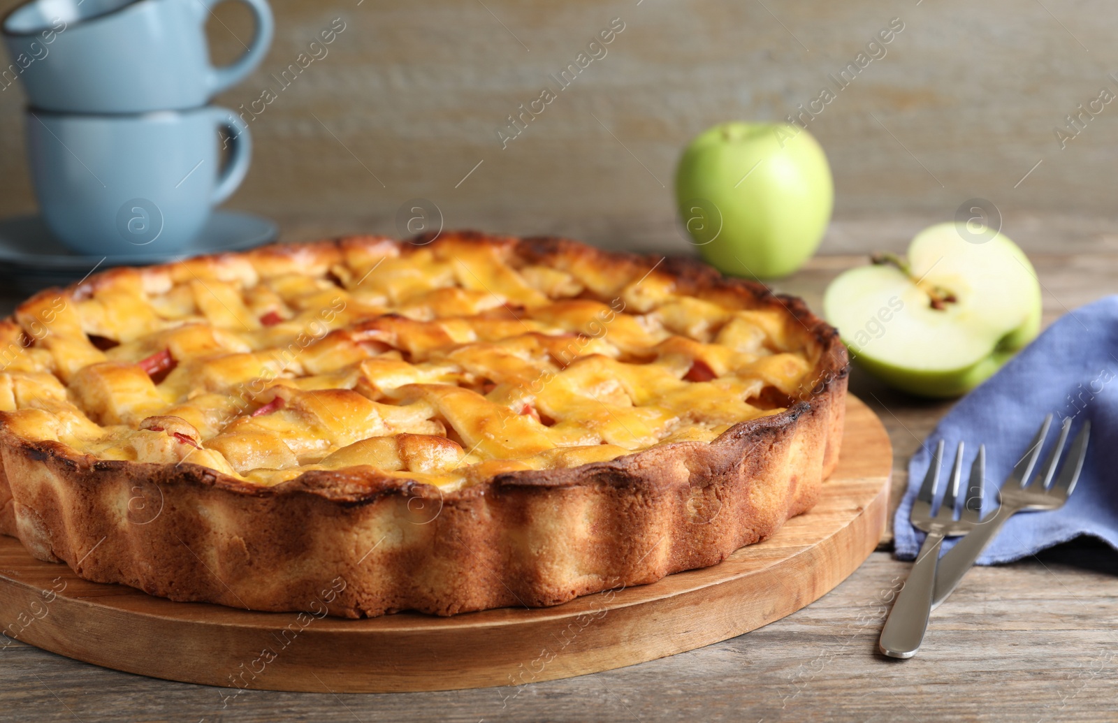 Photo of Fresh traditional apple pie on wooden table, closeup