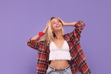 Photo of Portrait of happy hippie woman on purple background