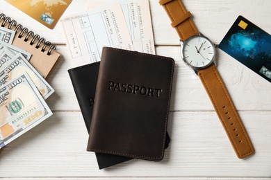 Flat lay composition with tourist items on wooden background. Travel agency