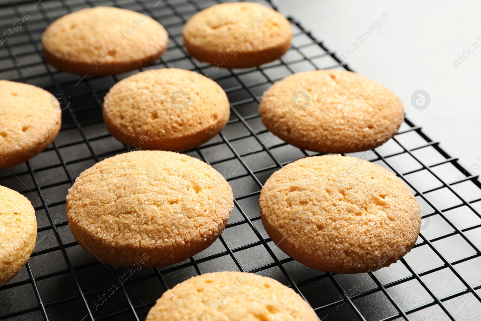 Photo of Baking grid with Danish butter cookies on table