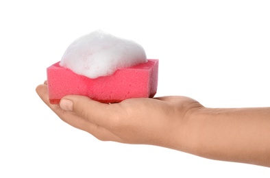 Photo of Woman holding cleaning sponge with foam for dish washing on white background, closeup