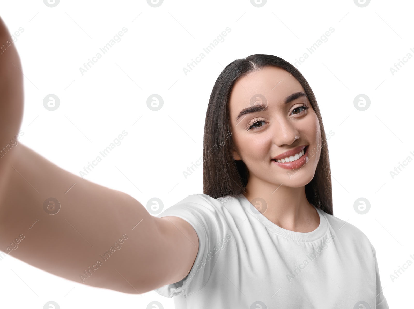 Photo of Smiling young woman taking selfie on white background