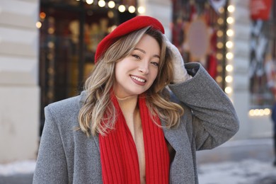 Portrait of smiling woman on city street in winter