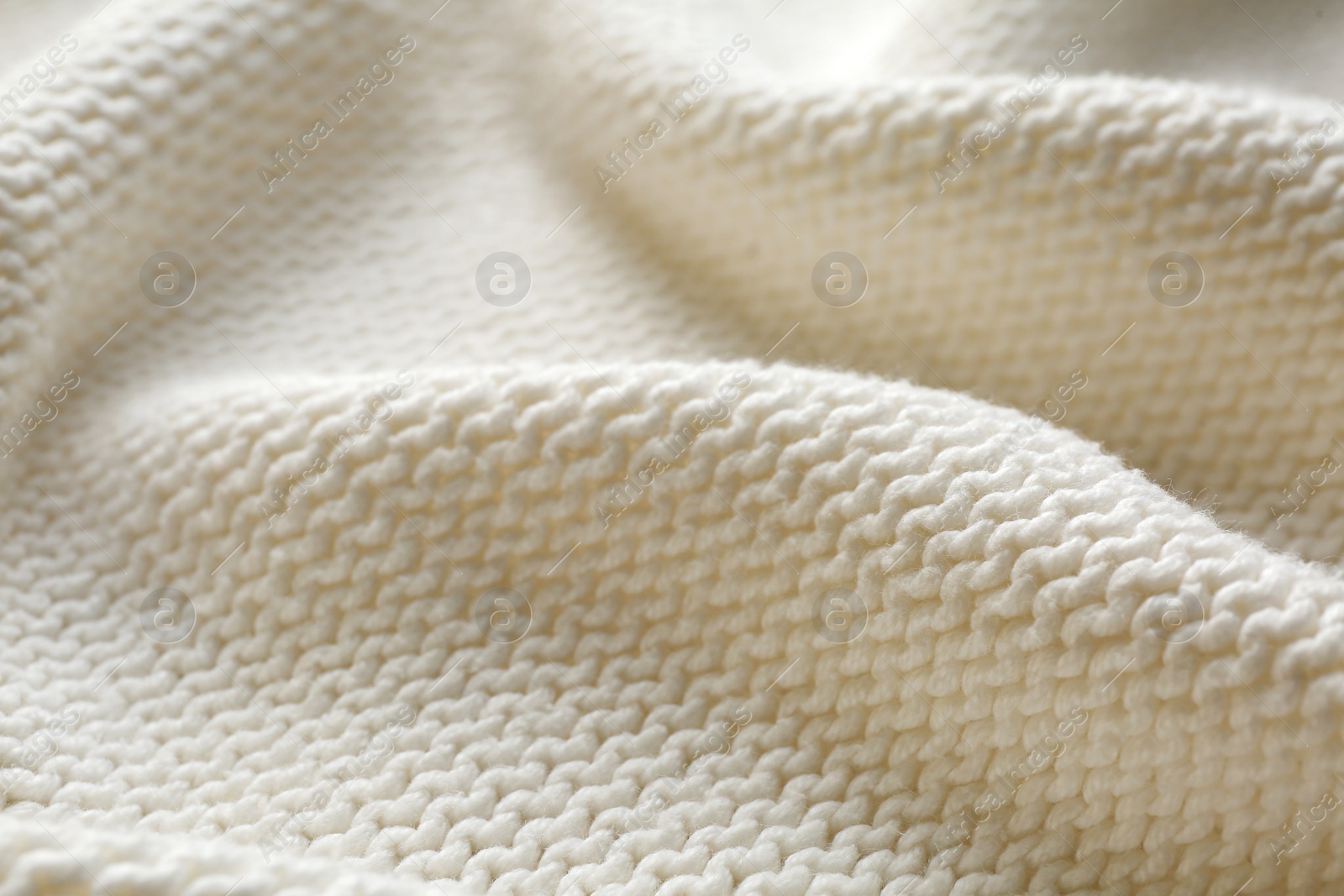 Photo of Beautiful white knitted fabric as background, closeup