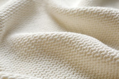 Photo of Beautiful white knitted fabric as background, closeup