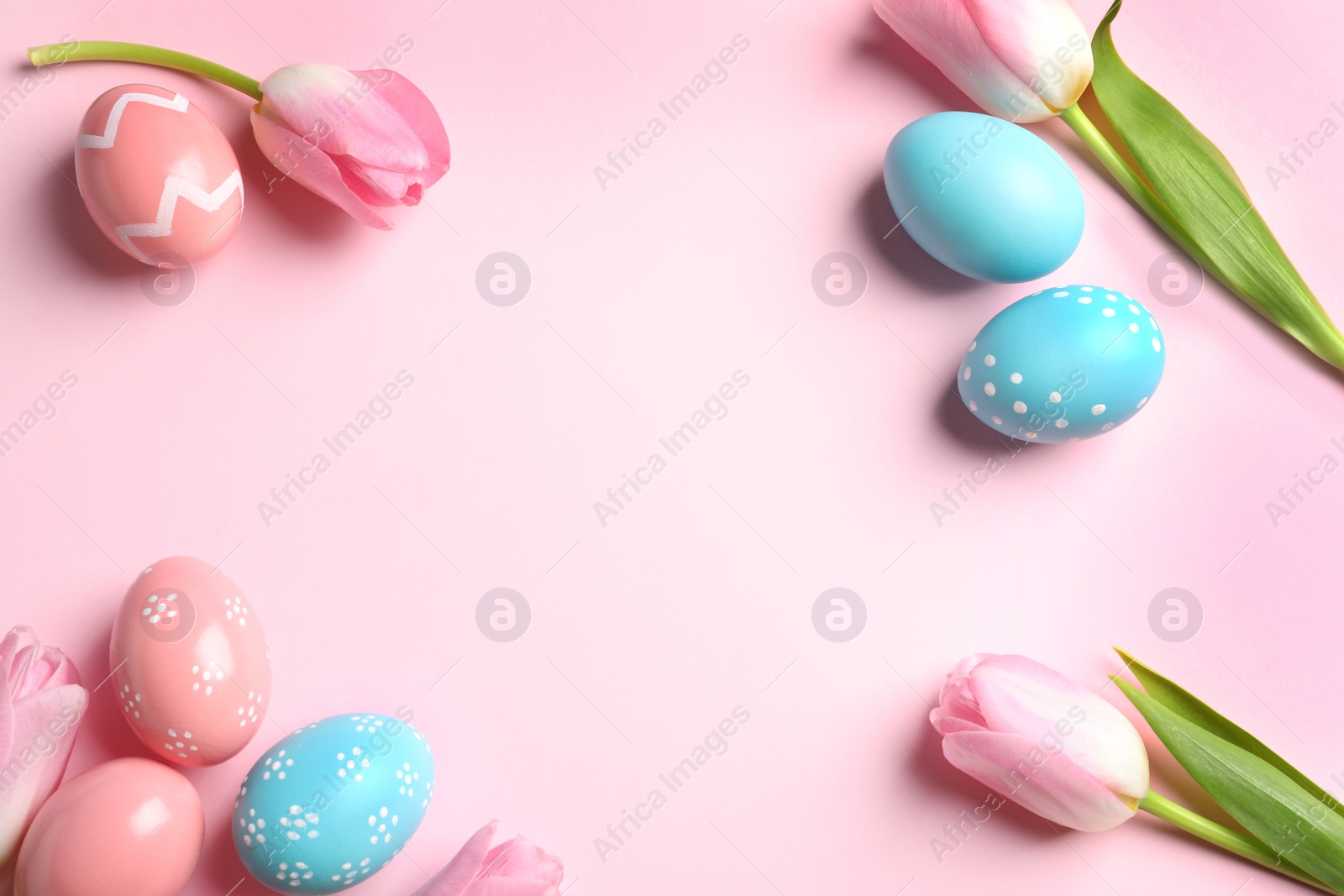 Photo of Flat lay composition with painted Easter eggs on color background, space for text