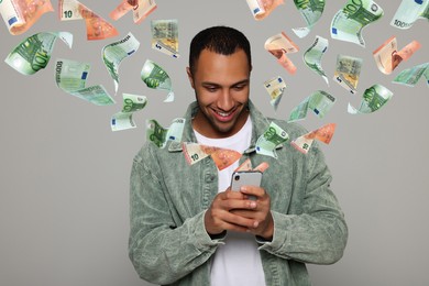 Image of Online payment. Man buying something using mobile phone on light grey background. Euro banknotes flying out of gadget demonstrating process of money transaction