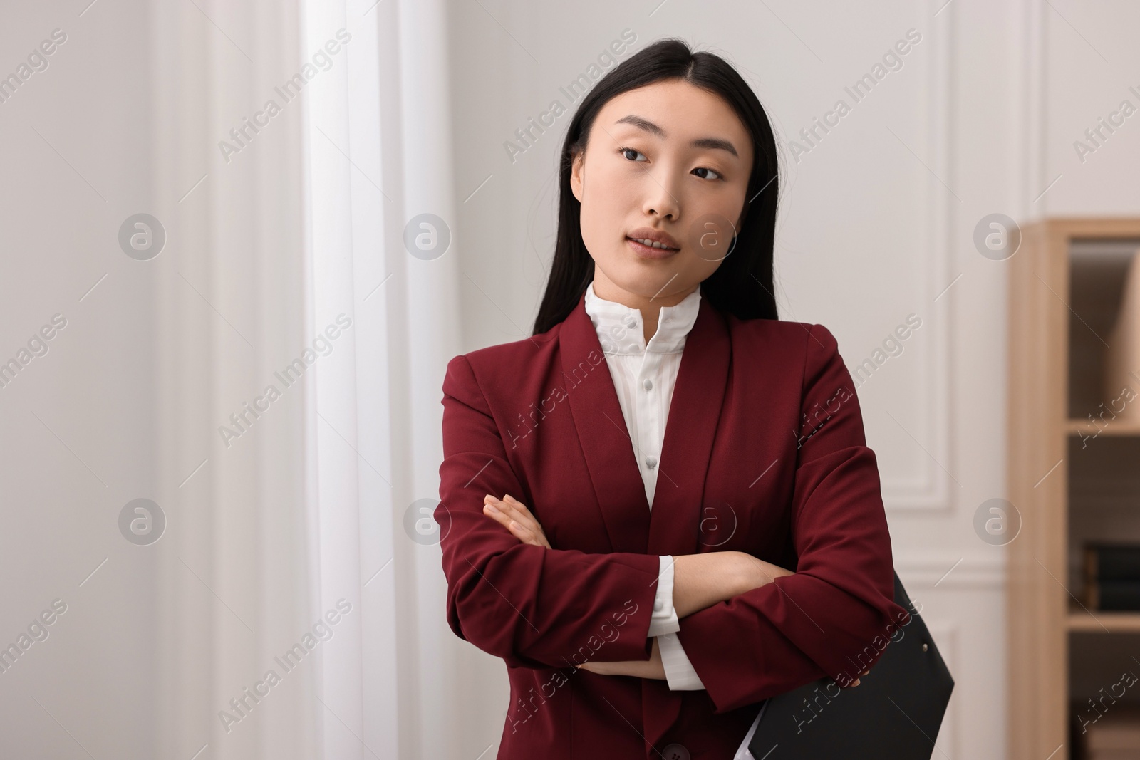 Photo of Portrait of notary with crossed arms in office. Space for text