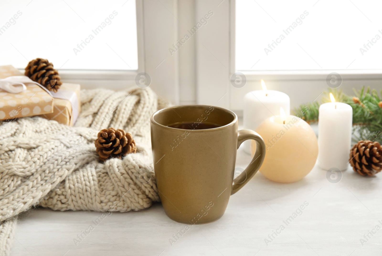 Photo of Composition with cup of hot winter drink near window. Cozy season