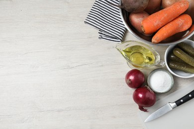 Photo of Many fresh vegetables and other ingredients on white wooden table, flat lay with space for text. Cooking vinaigrette salad