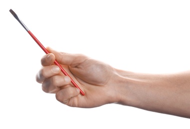 Photo of Man holding paint brush on white background, closeup