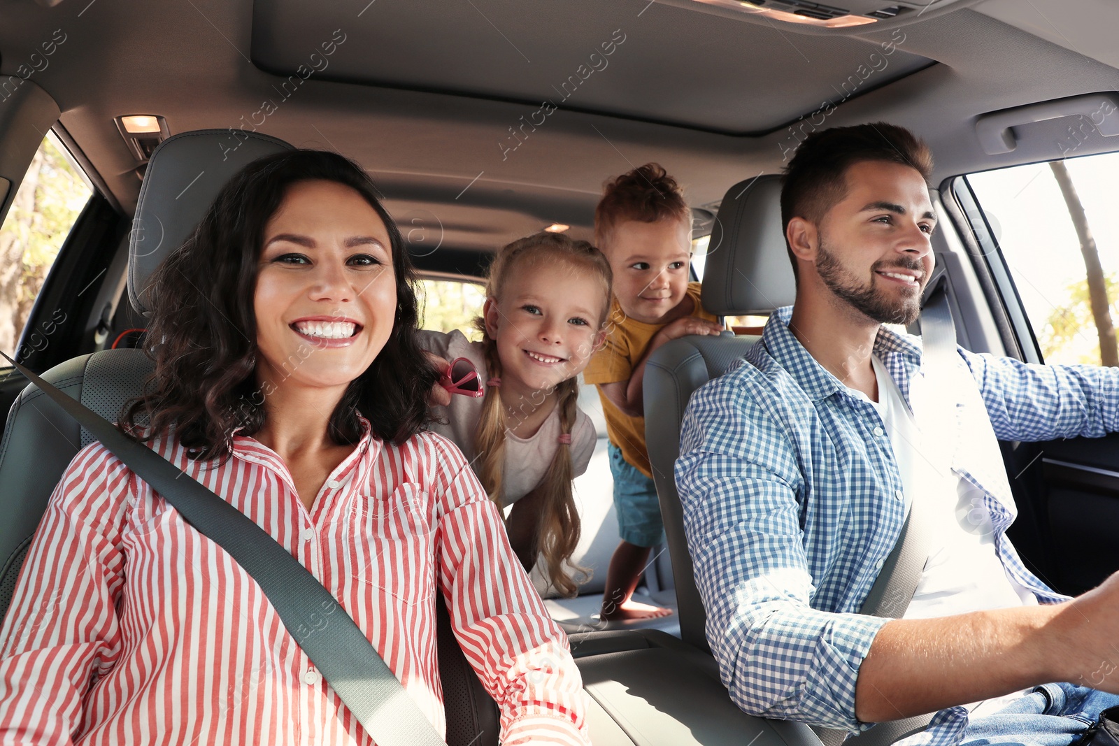 Photo of Happy family in car on road trip