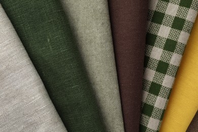 Photo of Many different fabrics as background, top view