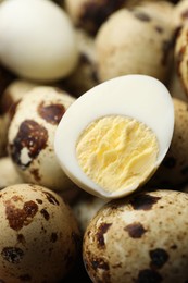 Heap of unpeeled and peeled hard boiled quail eggs as background, closeup