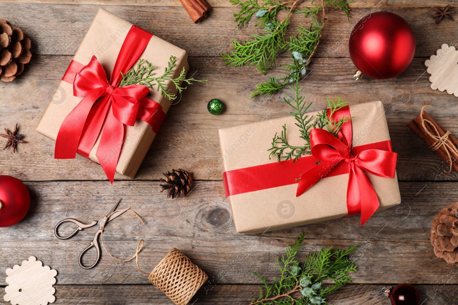 Photo of Flat lay composition with Christmas gifts and decoration on wooden background