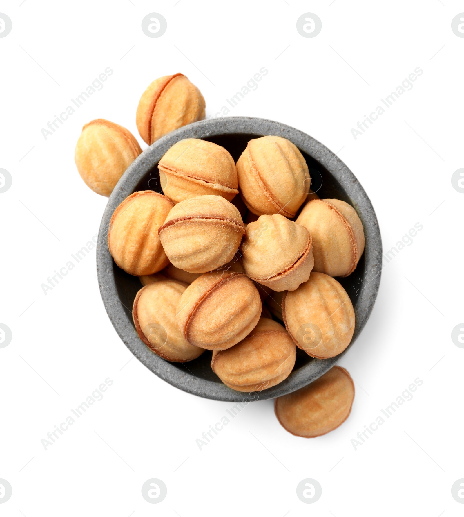 Photo of Bowl and delicious nut shaped cookies with condensed milk on white background, top view