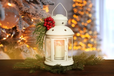 Composition with Christmas lantern on table in decorated room