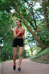 Photo of Beautiful woman in sportswear running in park