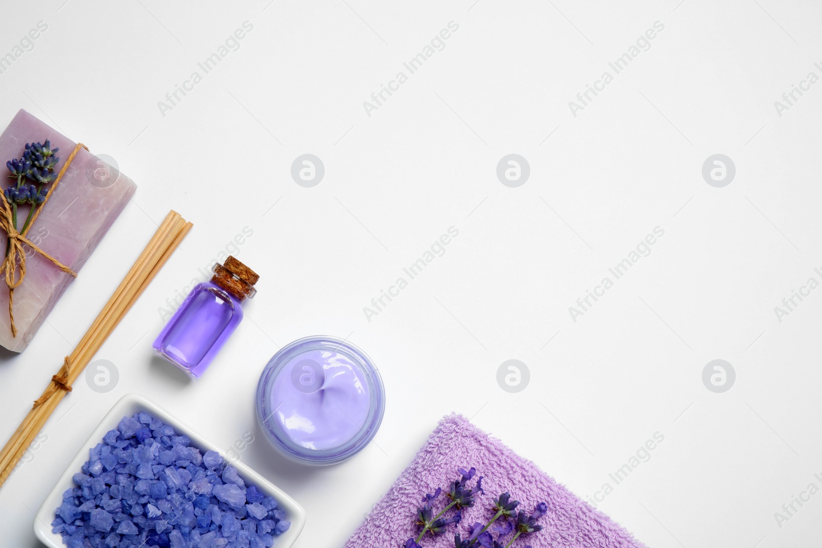 Photo of Cosmetic products and lavender flowers on white background, flat lay