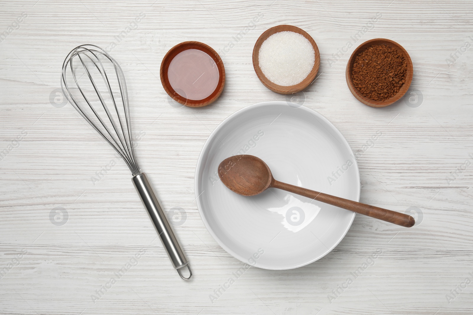 Photo of Flat lay composition with instant coffee granules and whisk on white wooden table