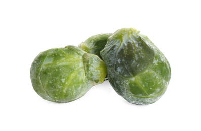 Photo of Frozen Brussels sprouts isolated on white. Vegetable preservation