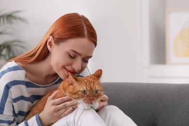 Photo of Woman with her cute cat at home, space for text