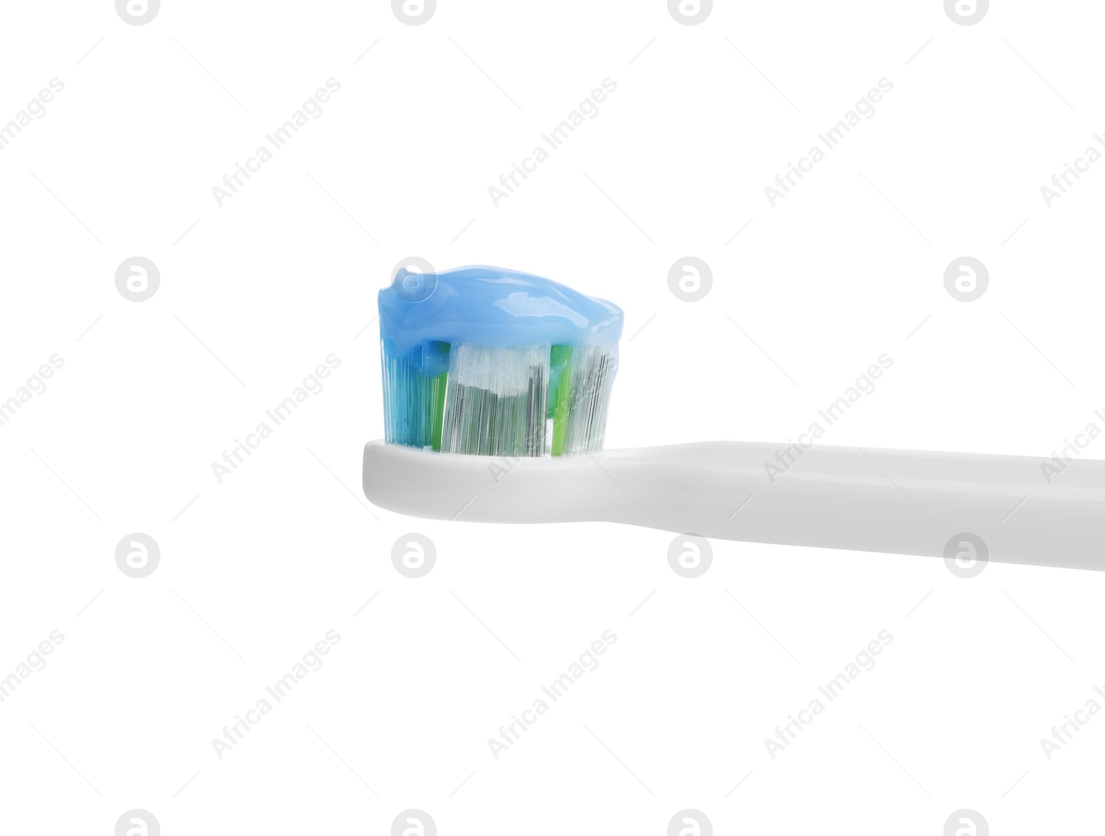 Photo of Applying paste on electric toothbrush against white background, closeup