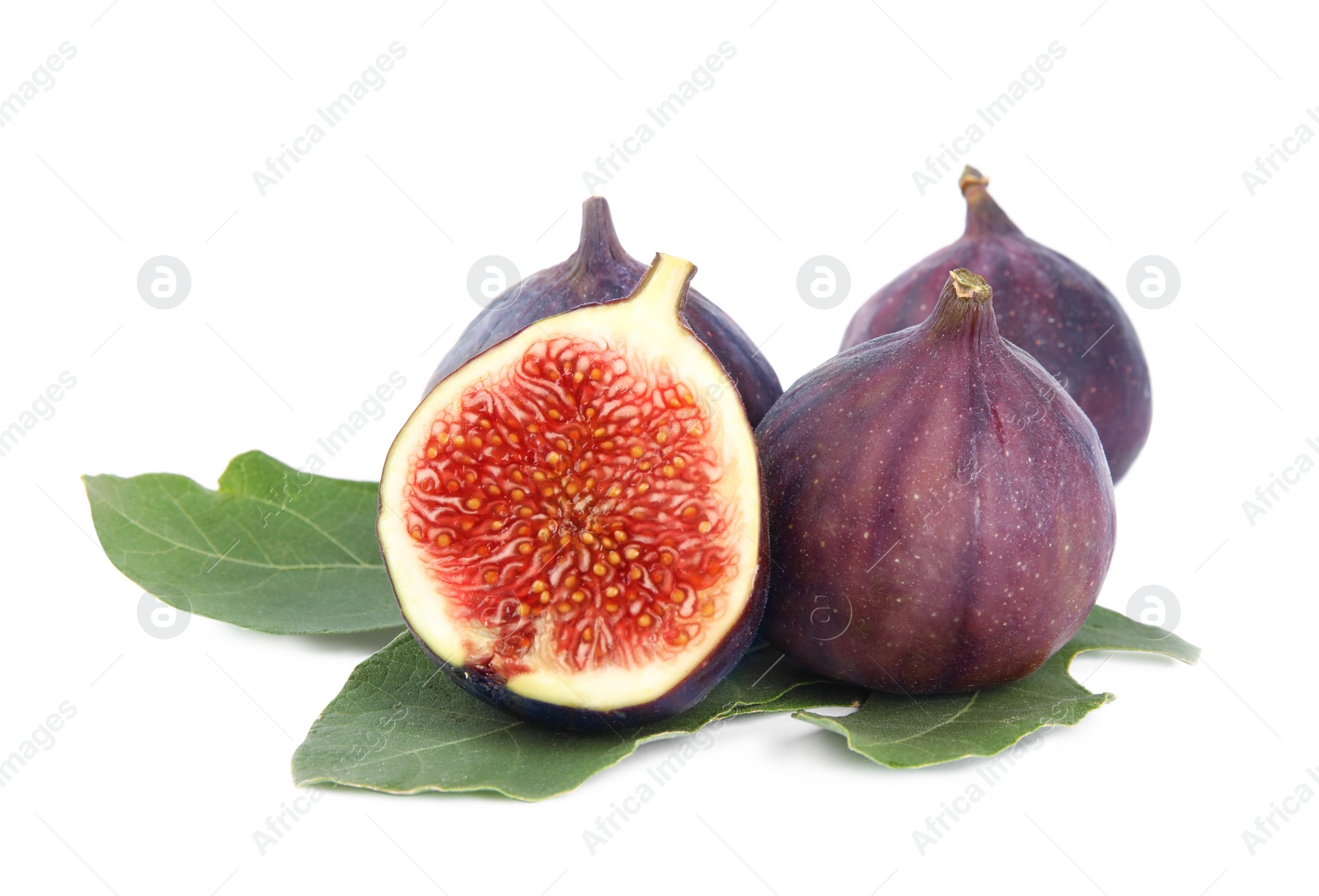 Photo of Fresh juicy purple figs and green leaves on white background