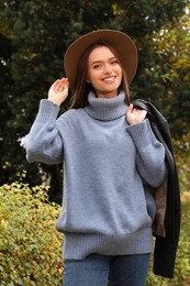 Beautiful young woman wearing stylish clothes in autumn park