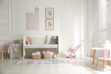 Baby room interior with stylish furniture and toys