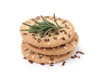 Photo of Stack of round cereal crackers with flax, sunflower, sesame seeds and rosemary isolated on white