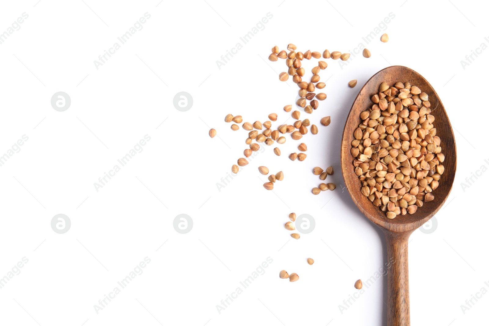 Photo of Spoon with uncooked buckwheat on white background, top view