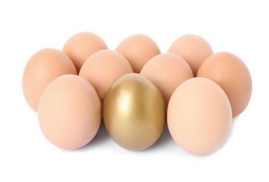 Photo of Golden egg among others on white background