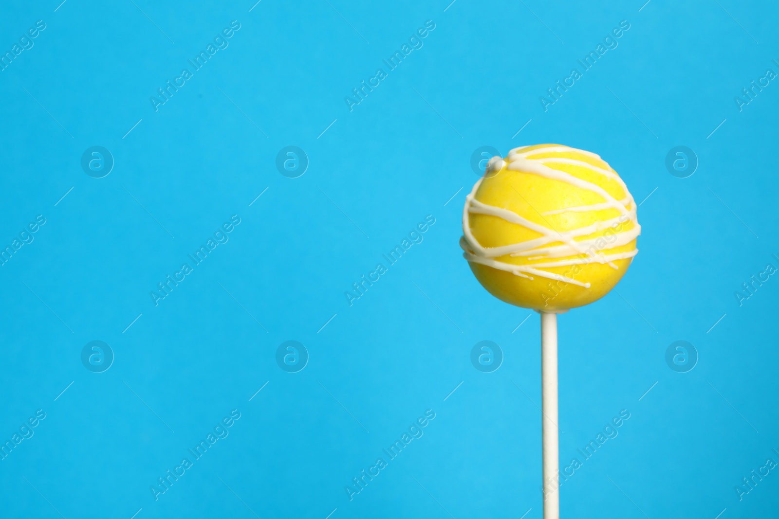 Photo of Bright delicious cake pop on color background. Space for text