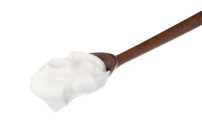 Wooden spoon with sour cream on white background