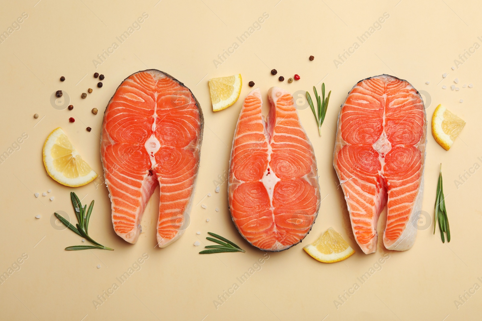 Photo of Flat lay composition with salmon steaks on light background