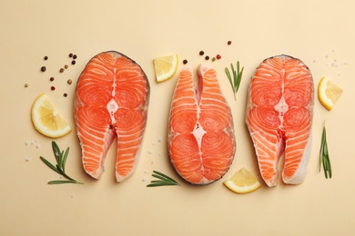 Flat lay composition with salmon steaks on light background