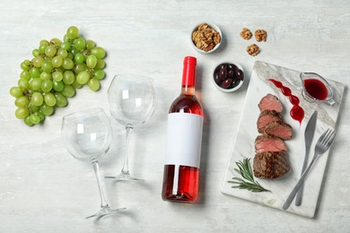 Photo of Flat lay composition with wine and food on white background. Space for design