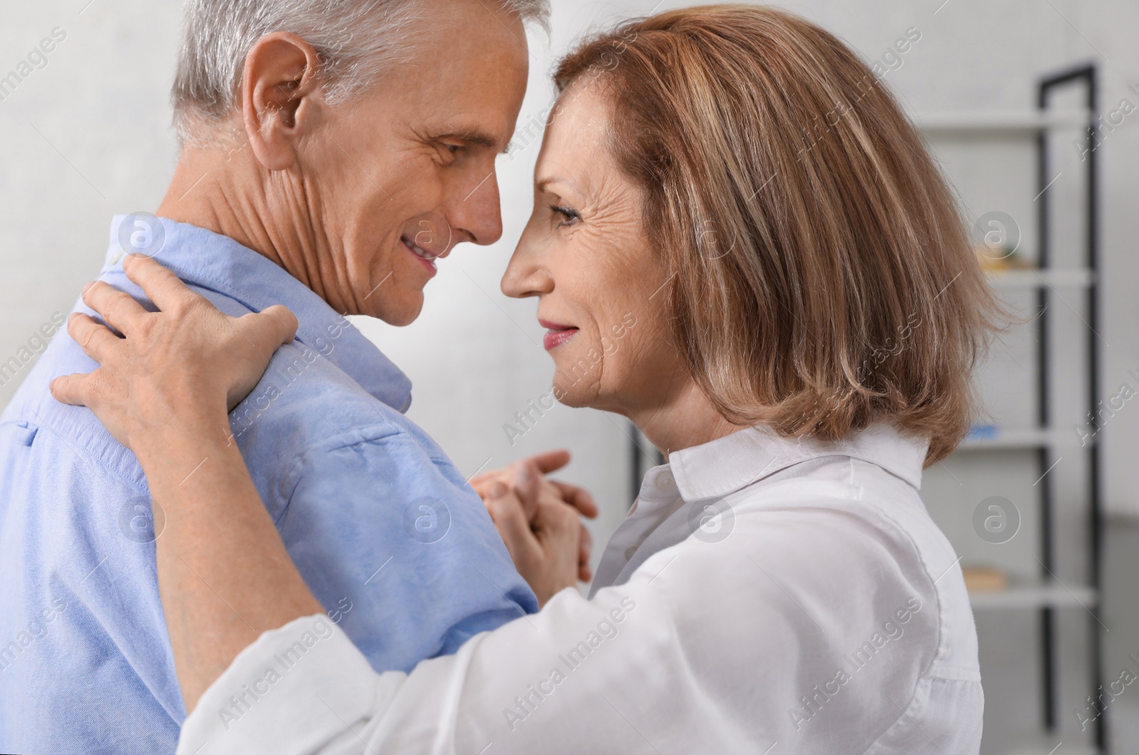 Photo of Happy senior couple dancing together at home, closeup