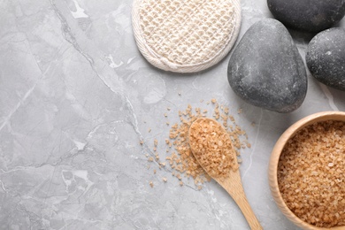 Photo of Flat lay composition with brown sea salt on marble background, space for text. Spa treatment