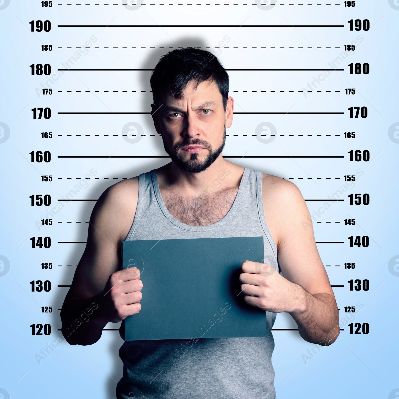 Image of Criminal mugshot. Arrested man with blank card against height chart