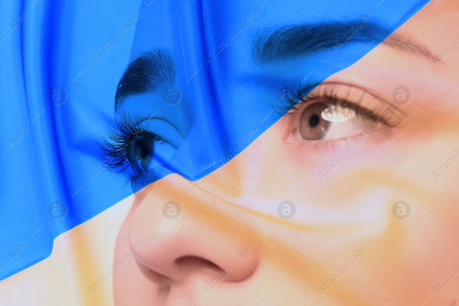 Image of Double exposure of Ukrainian national flag and young woman, closeup view