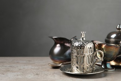 Vintage tea set on grey table, space for text