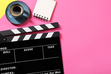 Photo of Movie clapper, coffee and notebook on color background, flat lay. Space for text