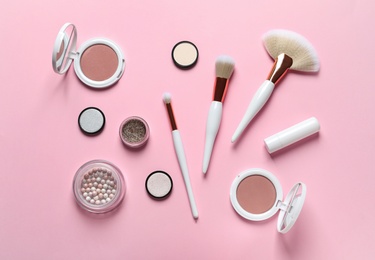 Photo of Flat lay composition with makeup brushes on pink background