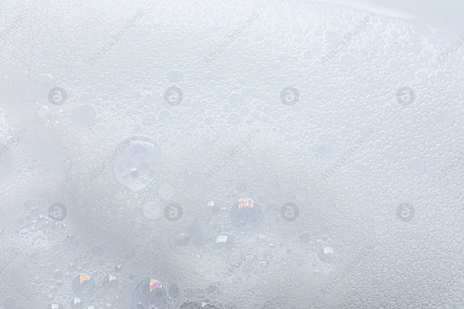 Photo of Fluffy soap foam as background, top view