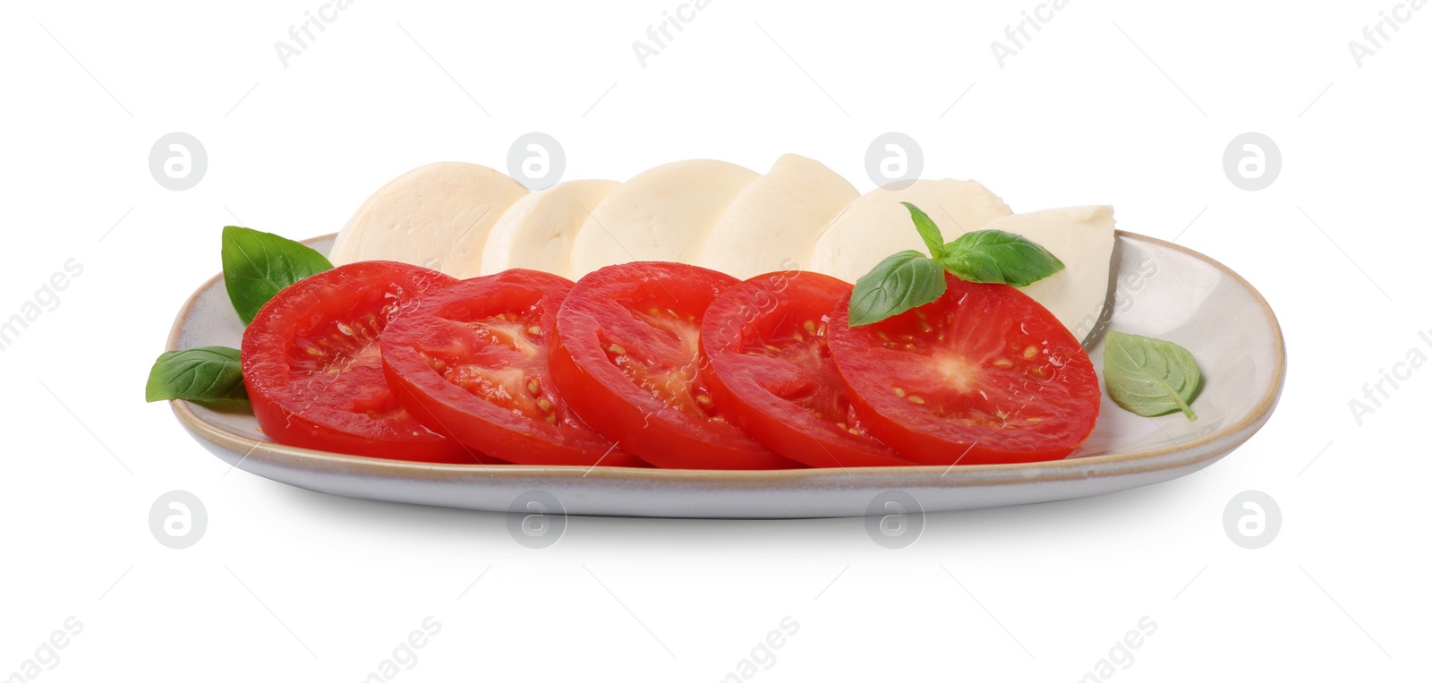 Photo of Plate of delicious Caprese salad with tomatoes, mozzarella and basil isolated on white