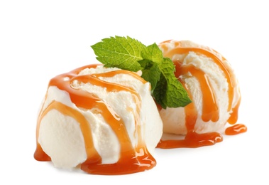 Scoops of delicious ice cream with caramel sauce and mint on white background